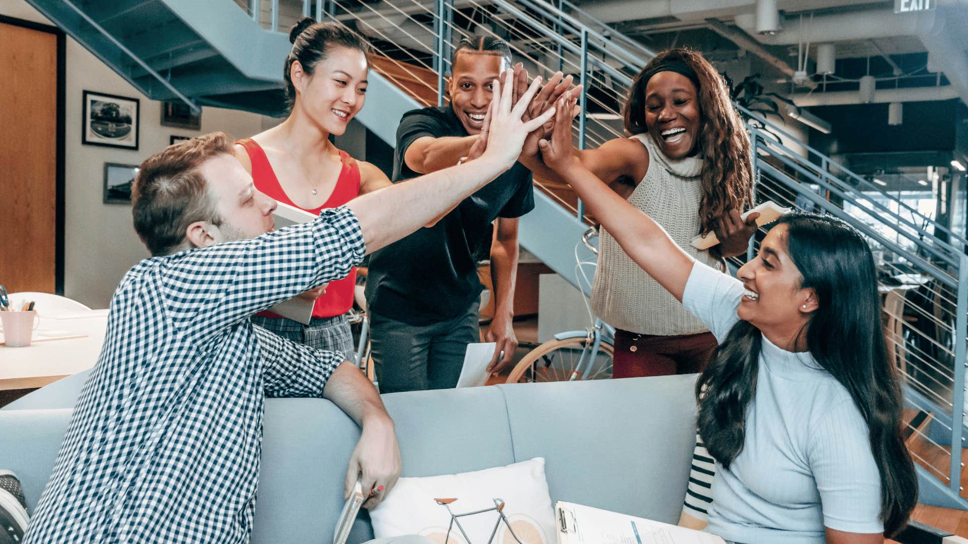 happy work team doing group high five