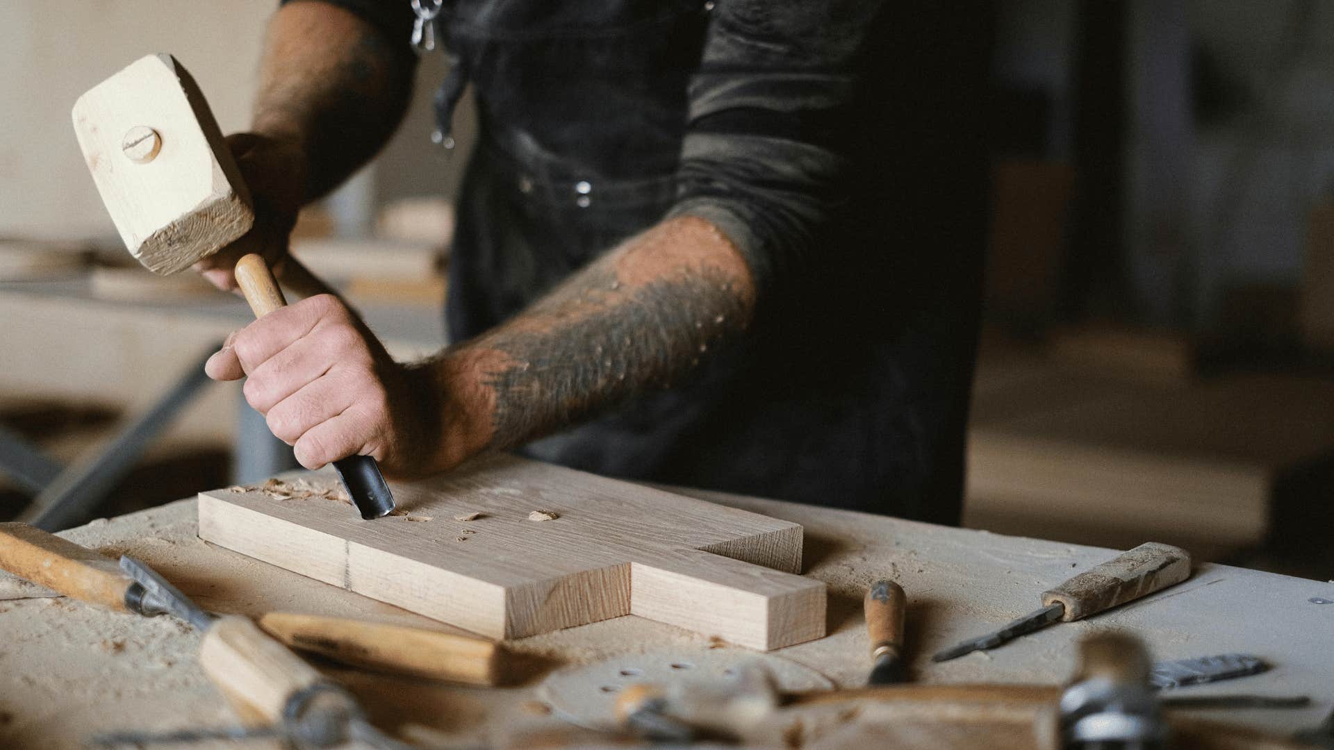 man working on wood carving project