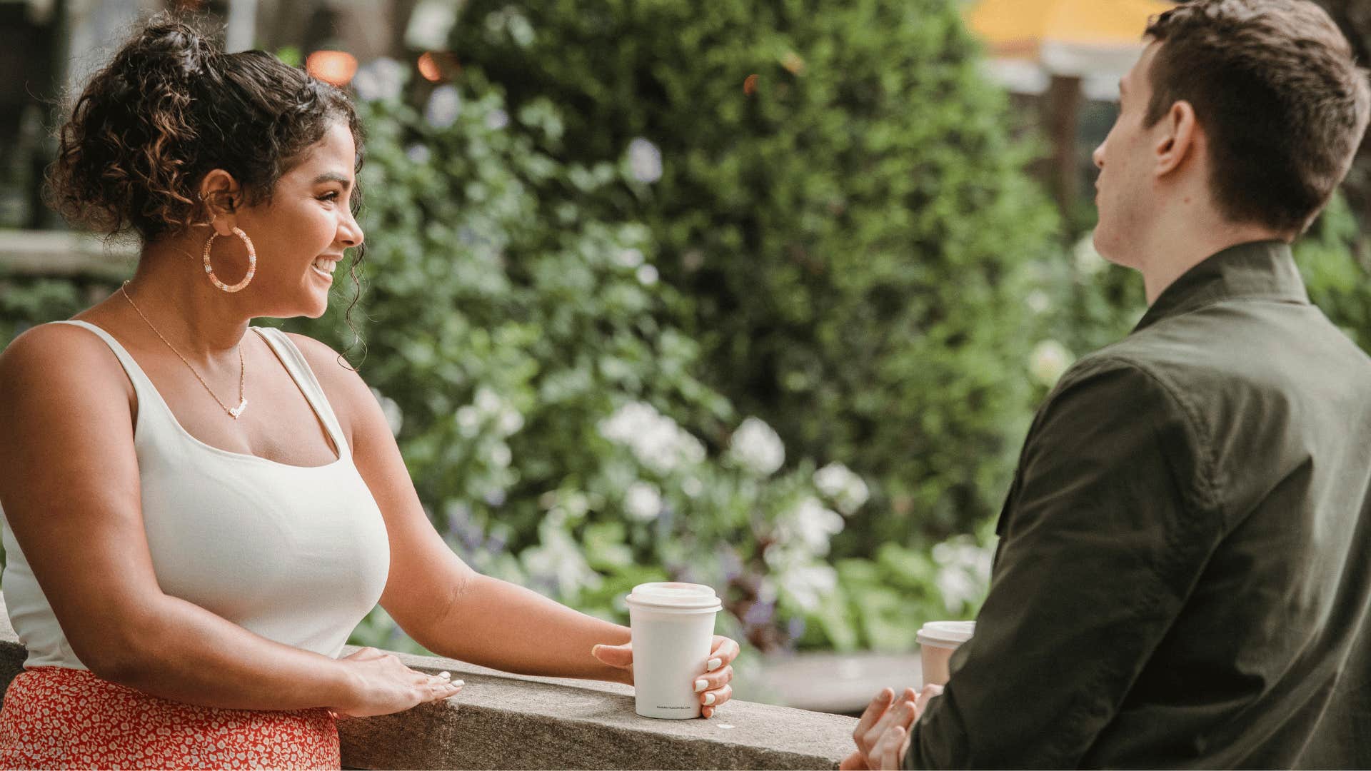 smiling woman talking to man