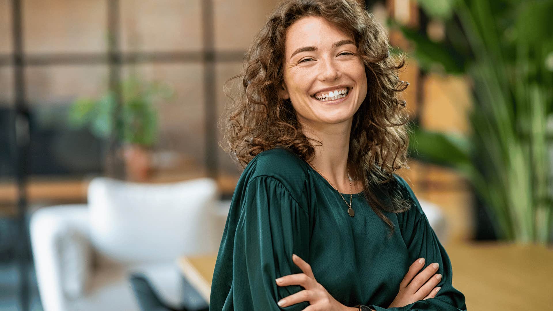 smiling young woman with crossed arms