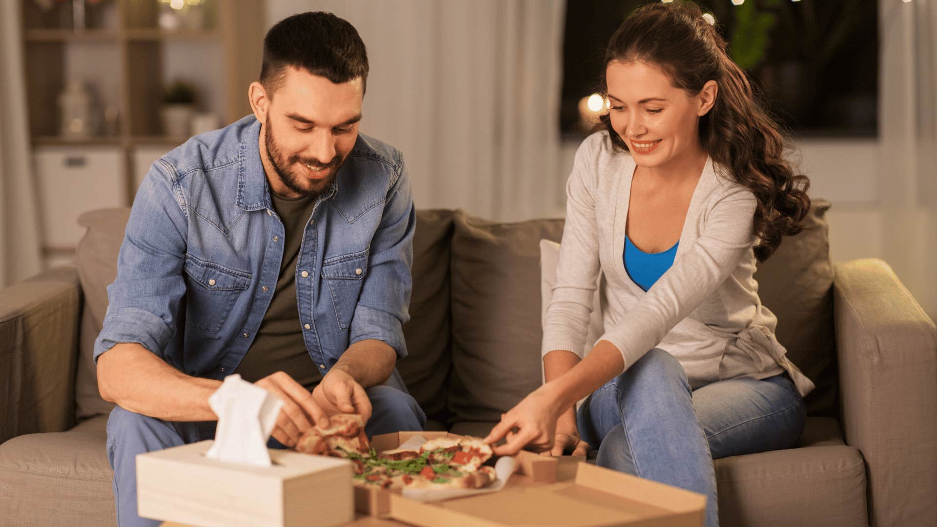 couple eating pizza at home