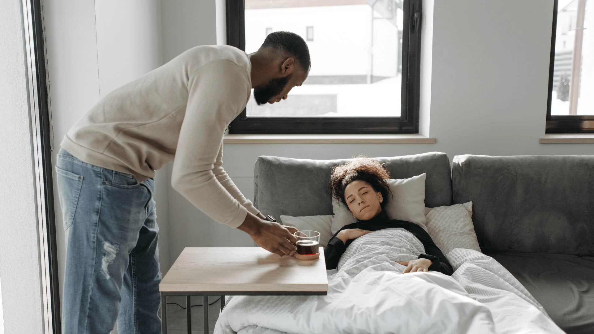 man caring for sick woman