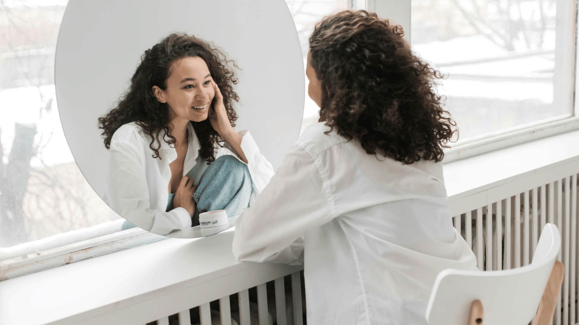 smiling woman looking at reflection