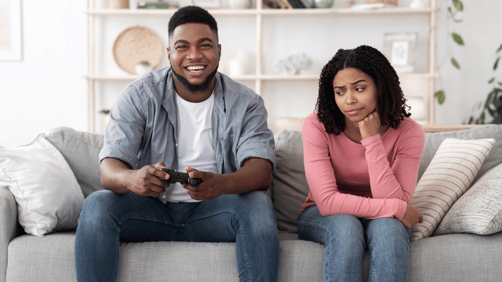 woman ignored by man playing video games