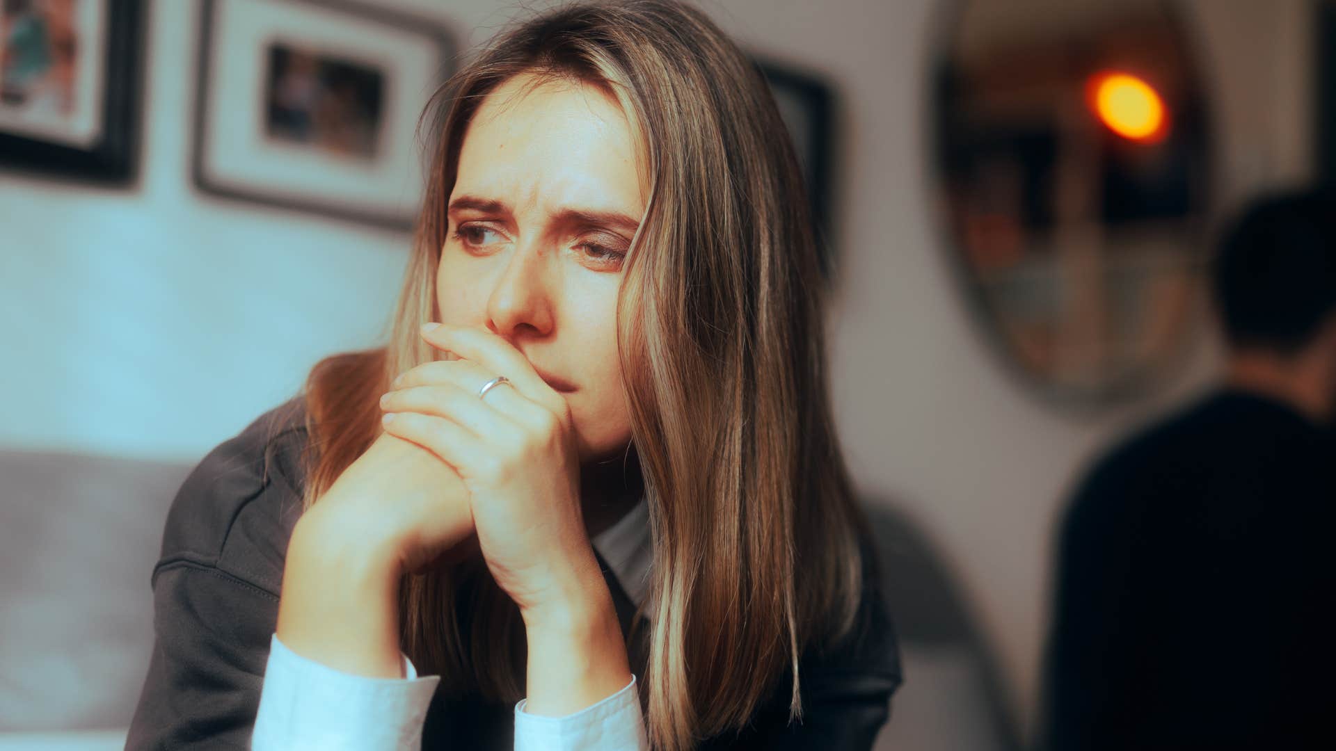 Woman looking serious, knowing she has stayed too long in relationship