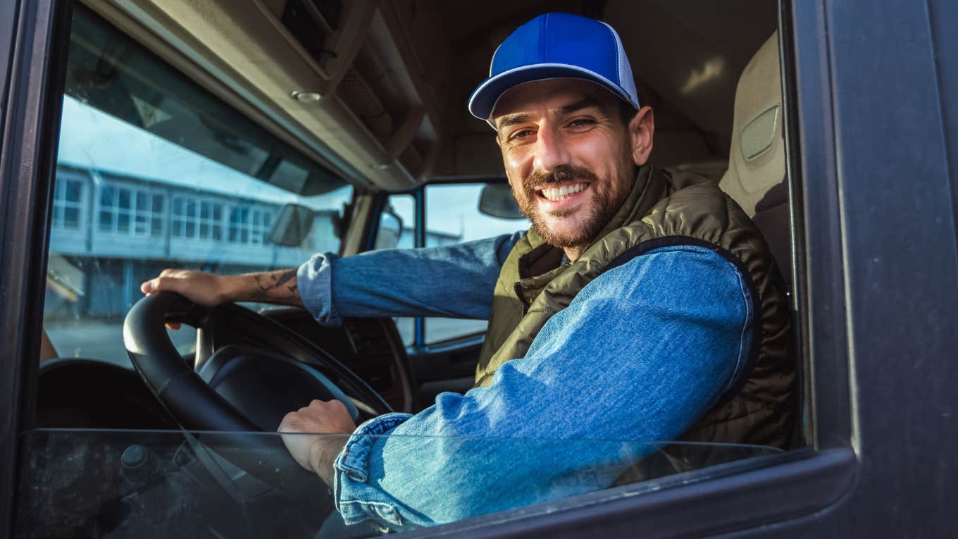 Truck driver smiling while working his job. 