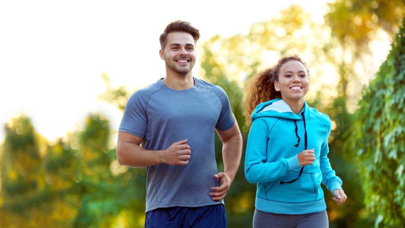 young man and woman go for a run outside together