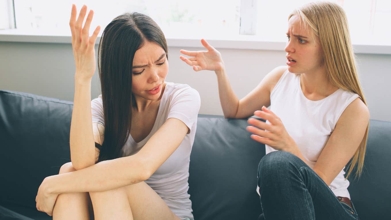 two female roommates argue over disagreement on couch at home