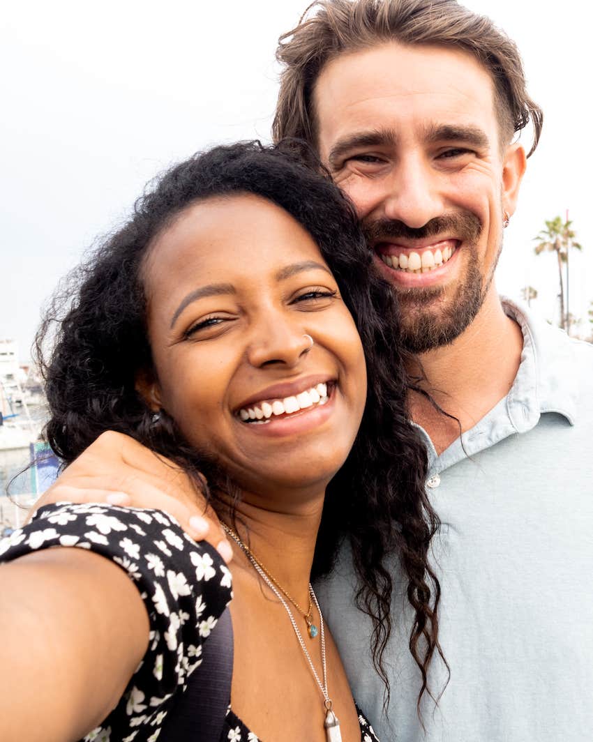 Happy couple smiles and enjoys being close