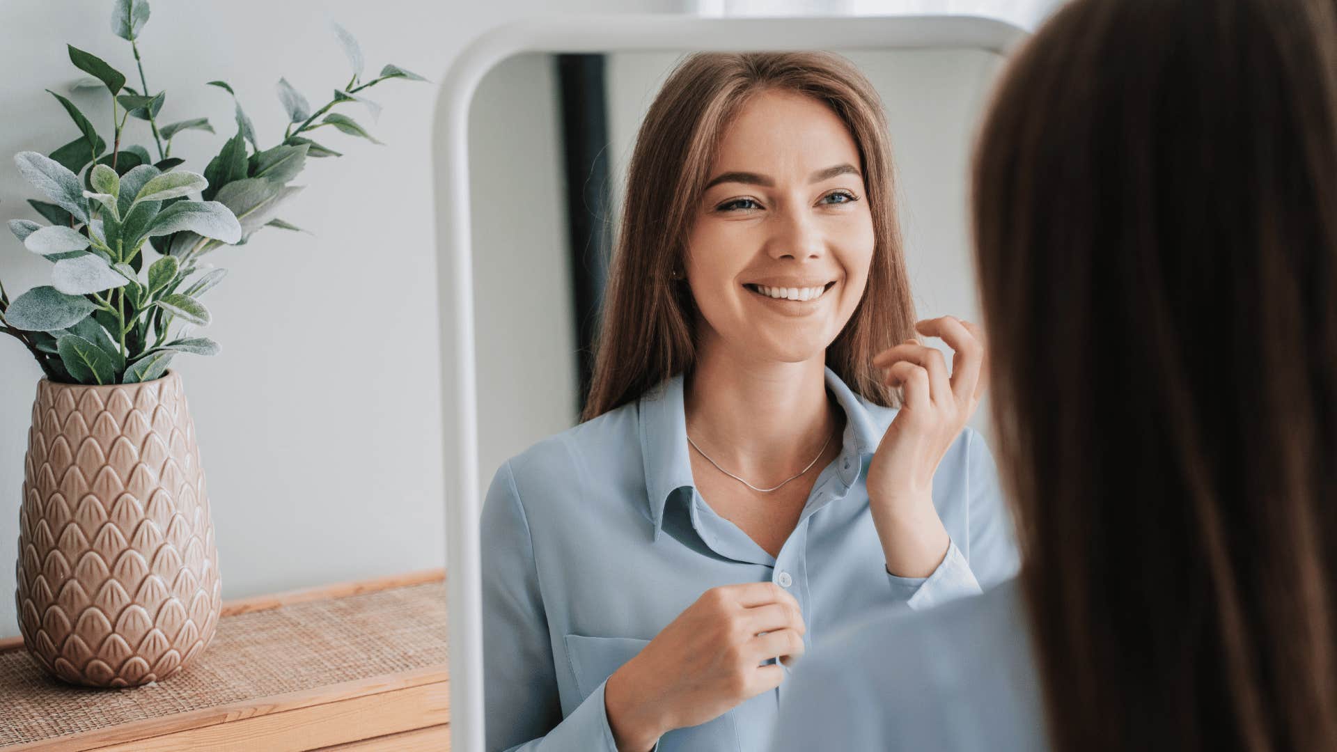 woman looking in mirror