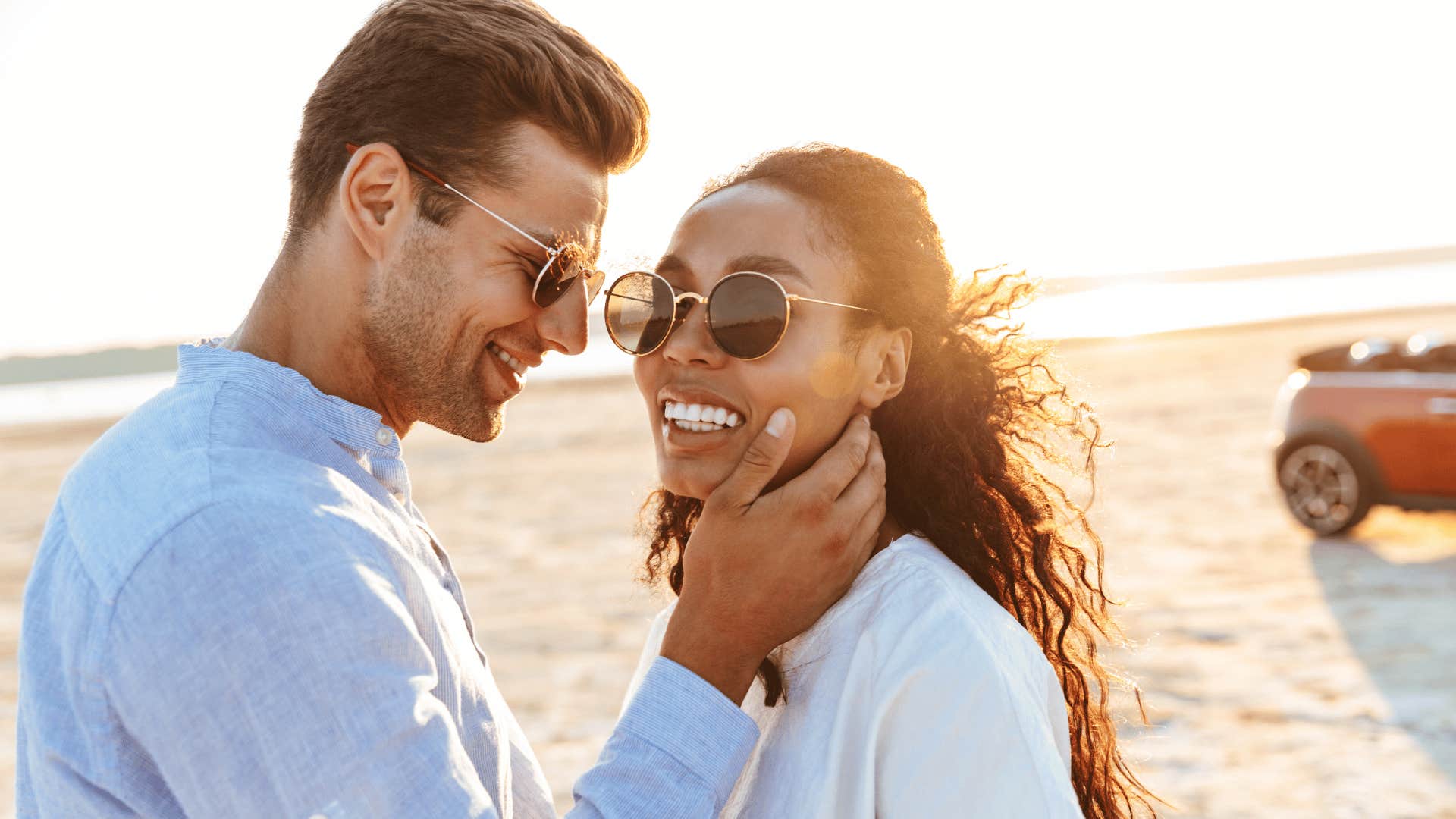 He lovingly touches her face on a visit to the beach