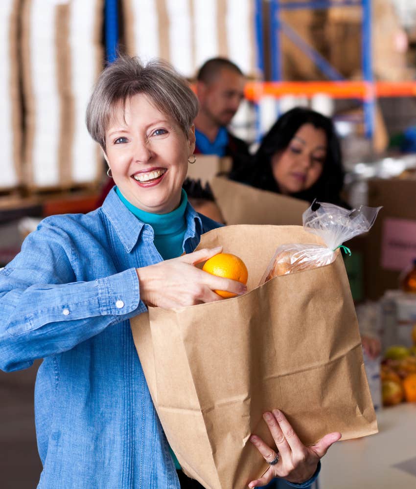 boomer mom with bag of groceries from food pantry