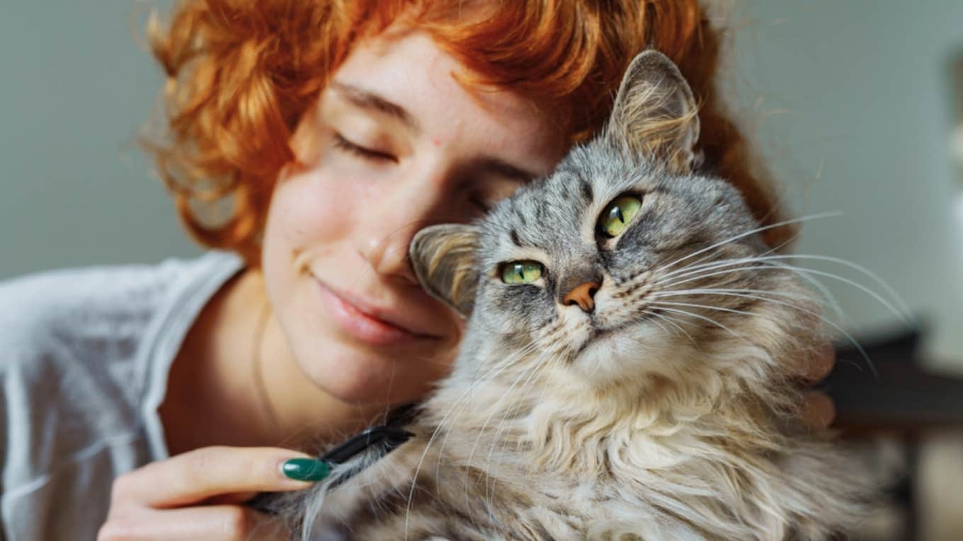 woman cuddling with cat 