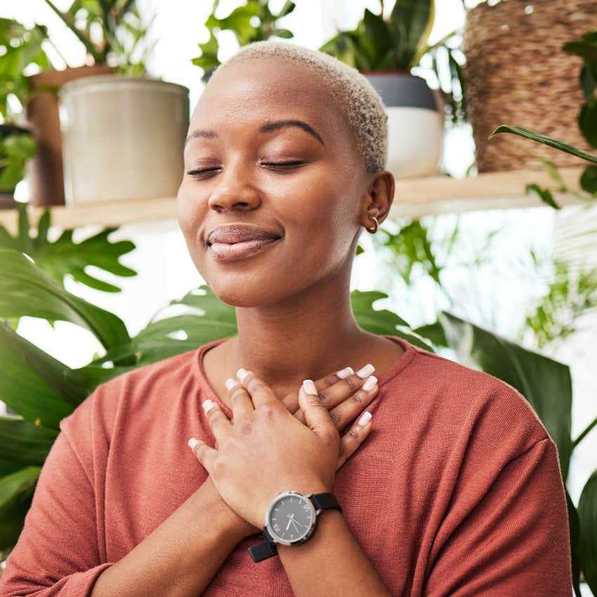 Calm and confident woman smiling with her eyes closed.