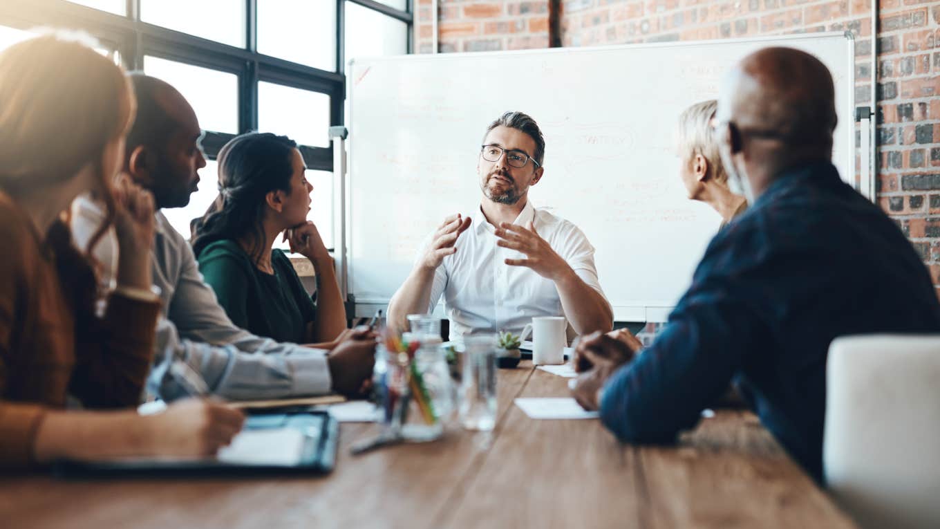 manager meeting with employees in conference room