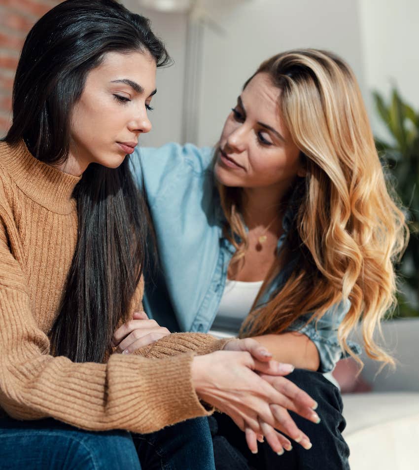 She gently holds her arm as they talk through an issue with compassion