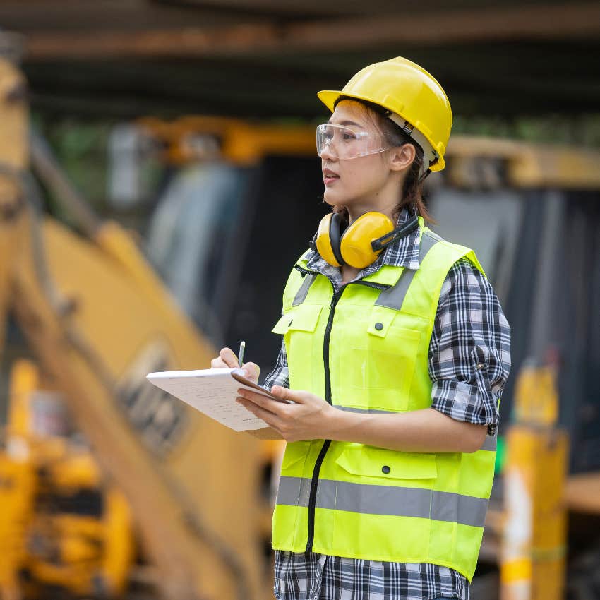 Gen Z woman working blue-collar job as a construction worker