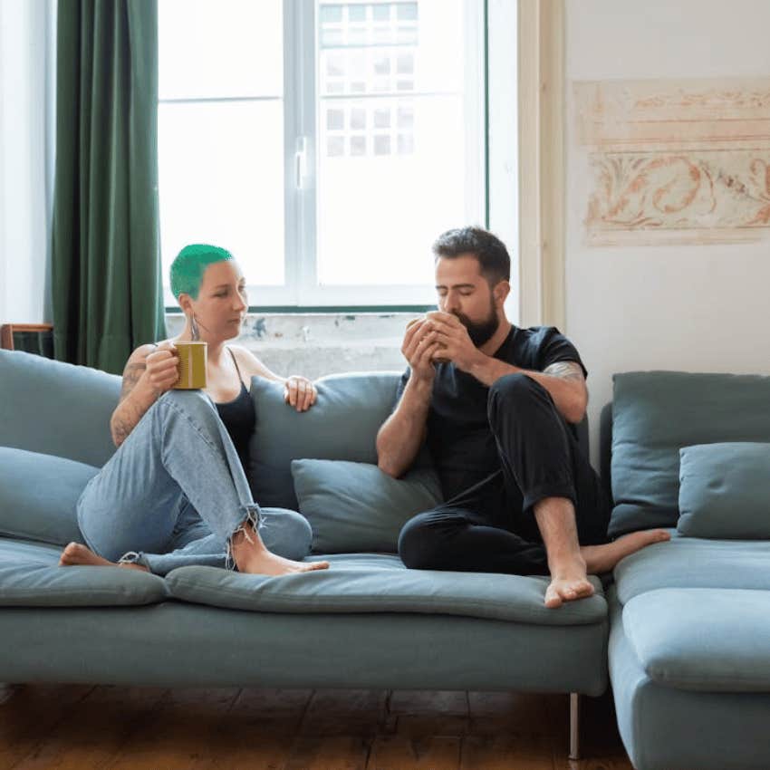 couple drinking coffee together on couch