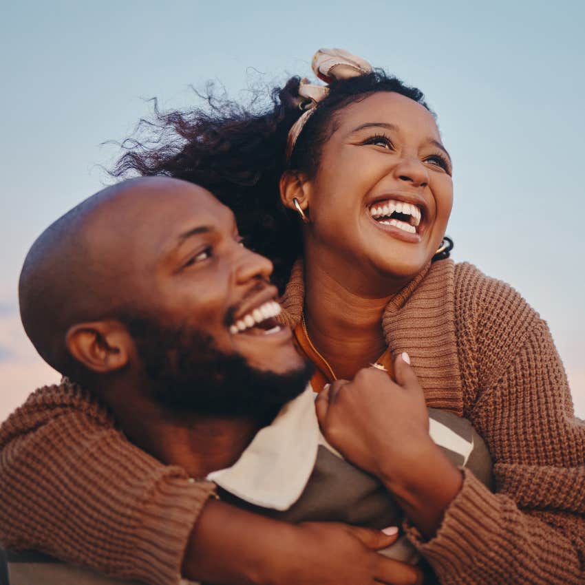 Couple hugging and smiling together. 