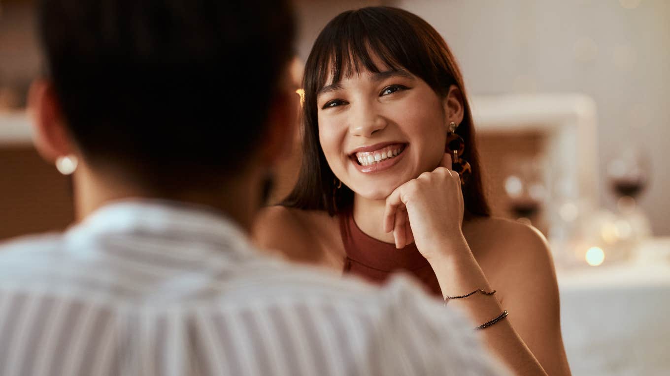 Woman smiling during a first date. 