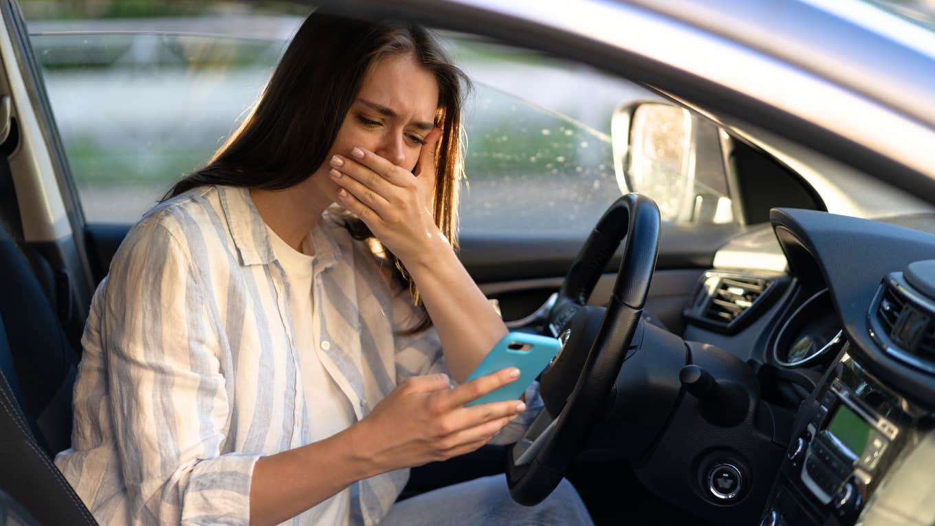 Woman crying after receiving text from husband, now former husband.