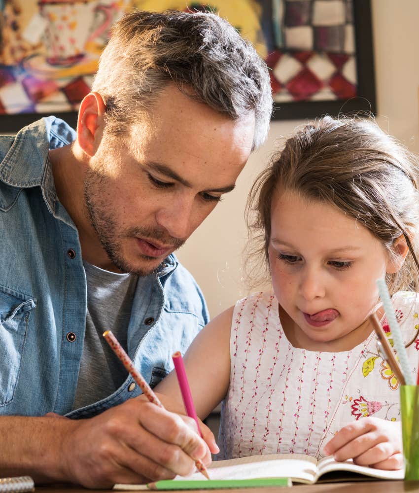 Dad and daughter coloring together