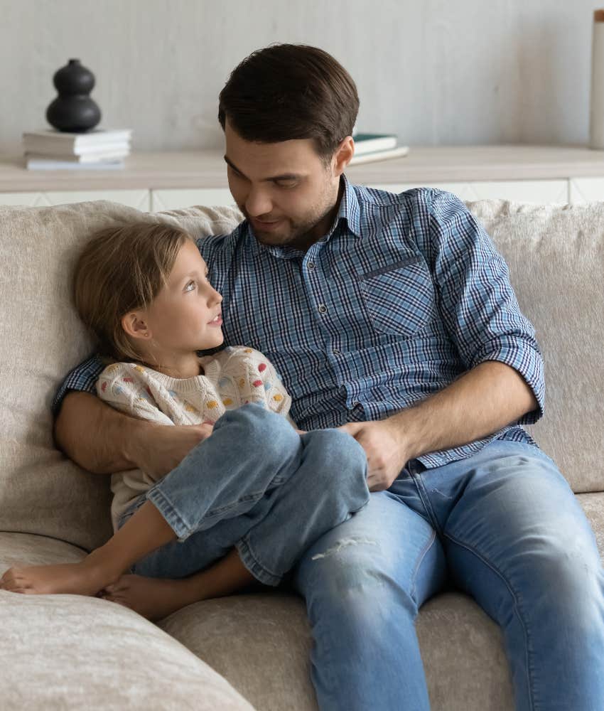 Dad and daughter sitting on the couch together