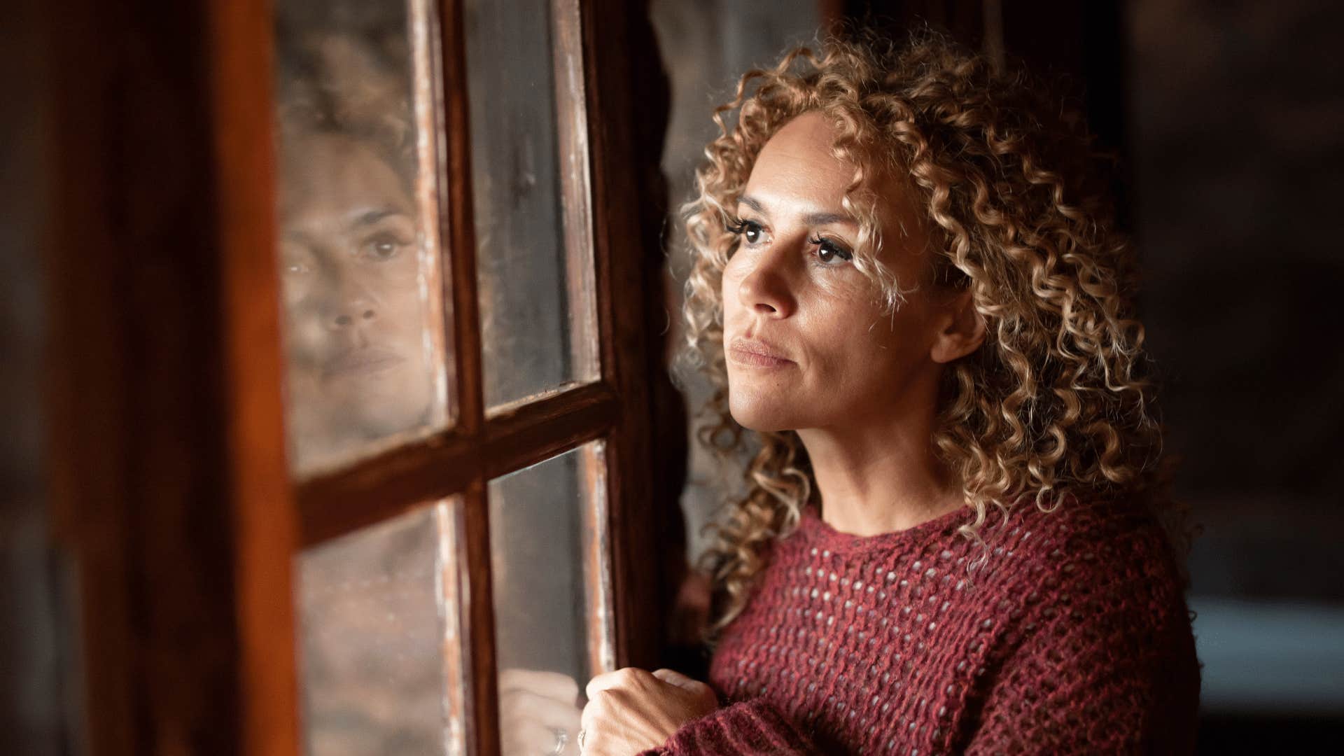 woman looking out the window