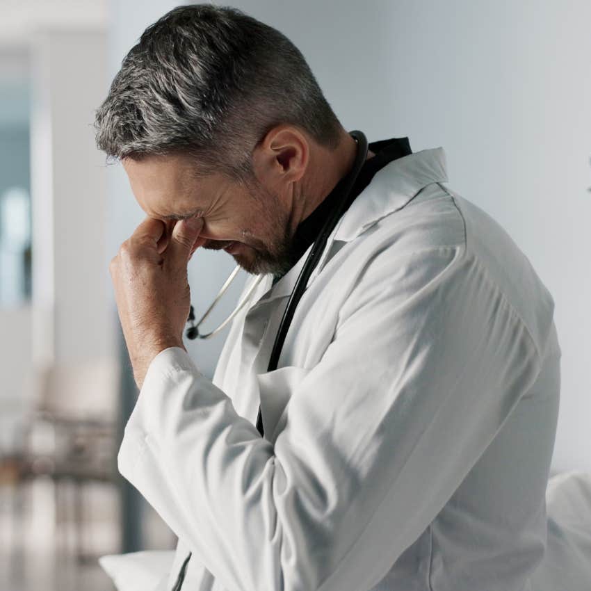 Doctor looking stressed after patient visit. 