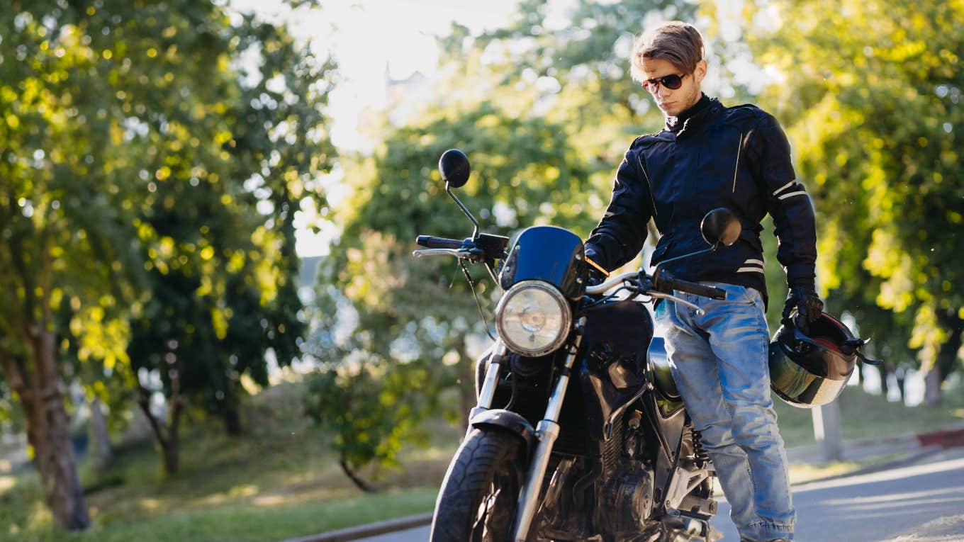 Man standing next to motorcycle 