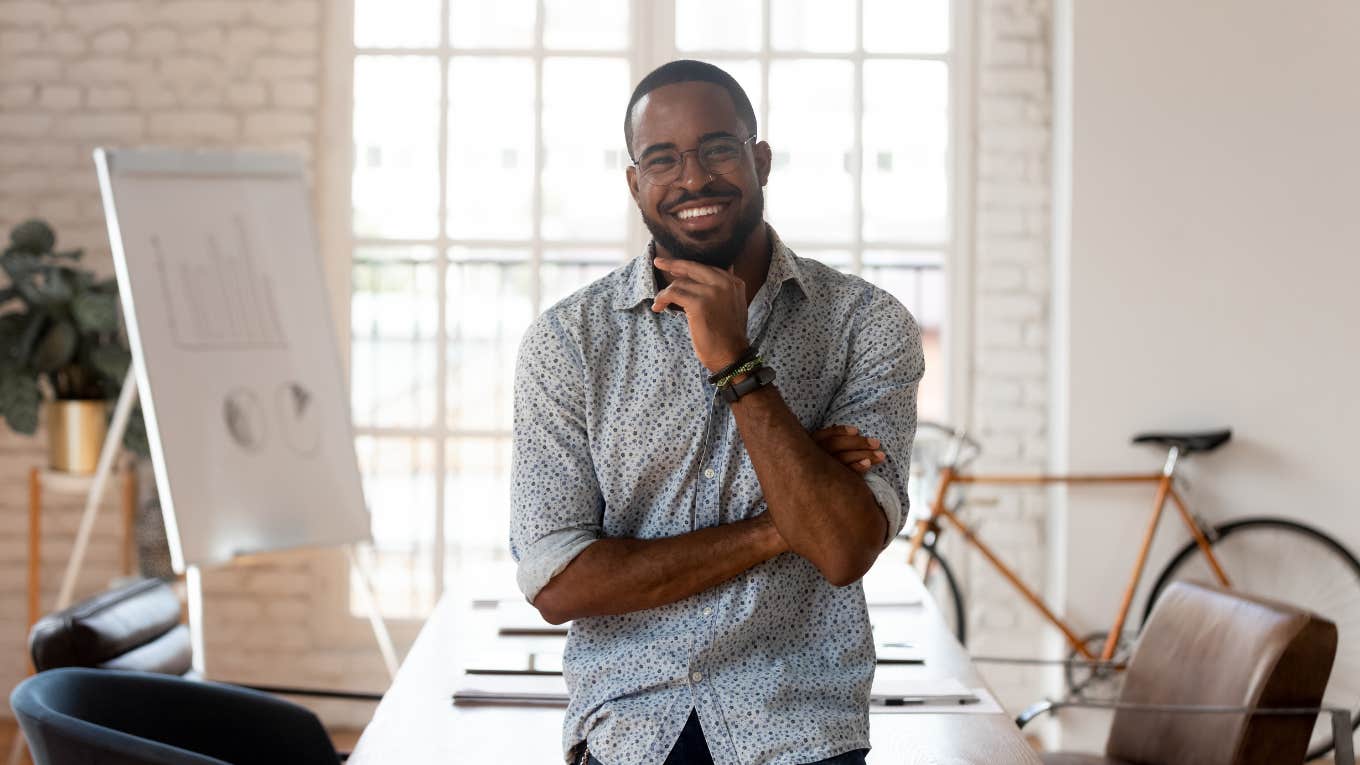 Employee smiling as he prepares to say goodbye to co-workers