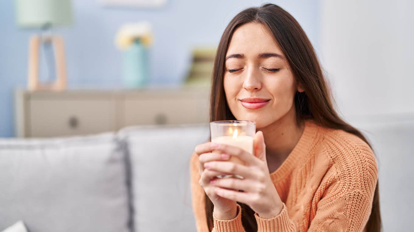 American woman smelling a candle