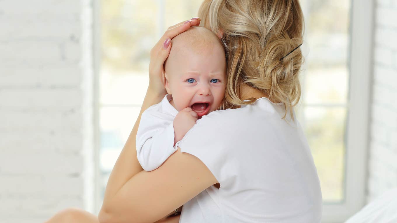 Mom holding crying newborn baby