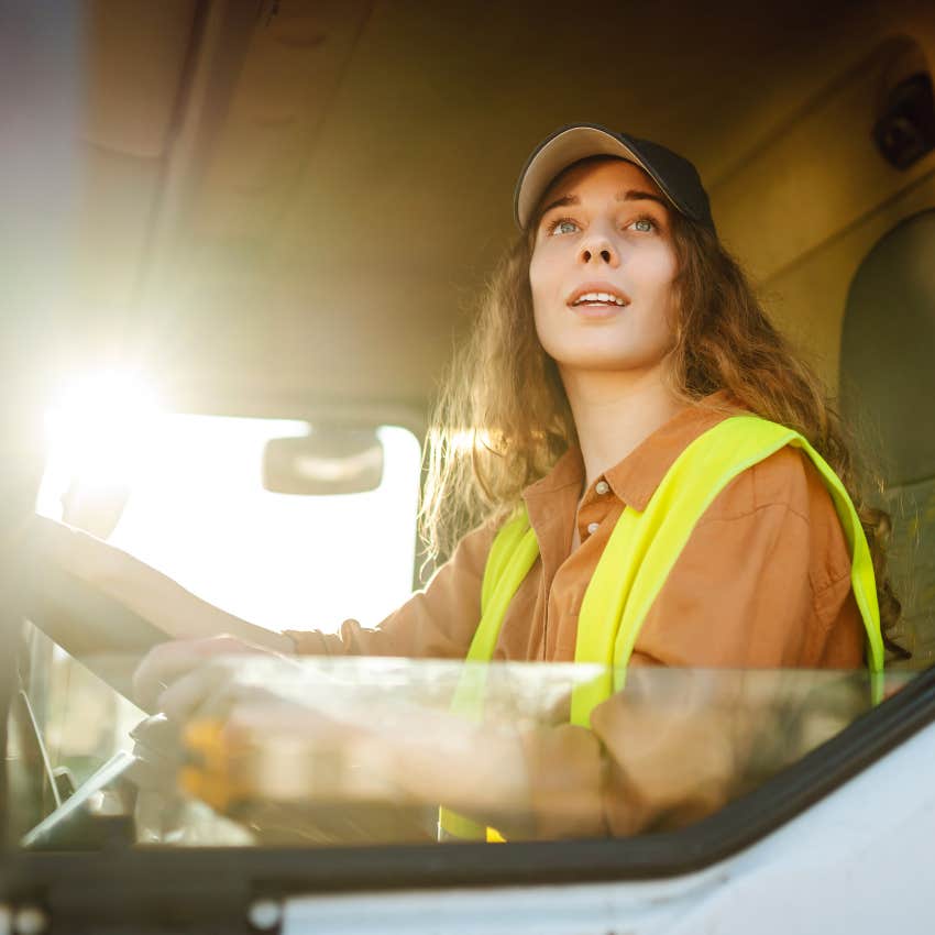 Female truck driver doing her job. 