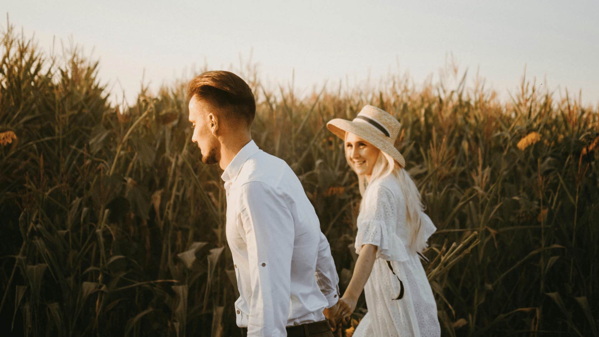 couple walking through field