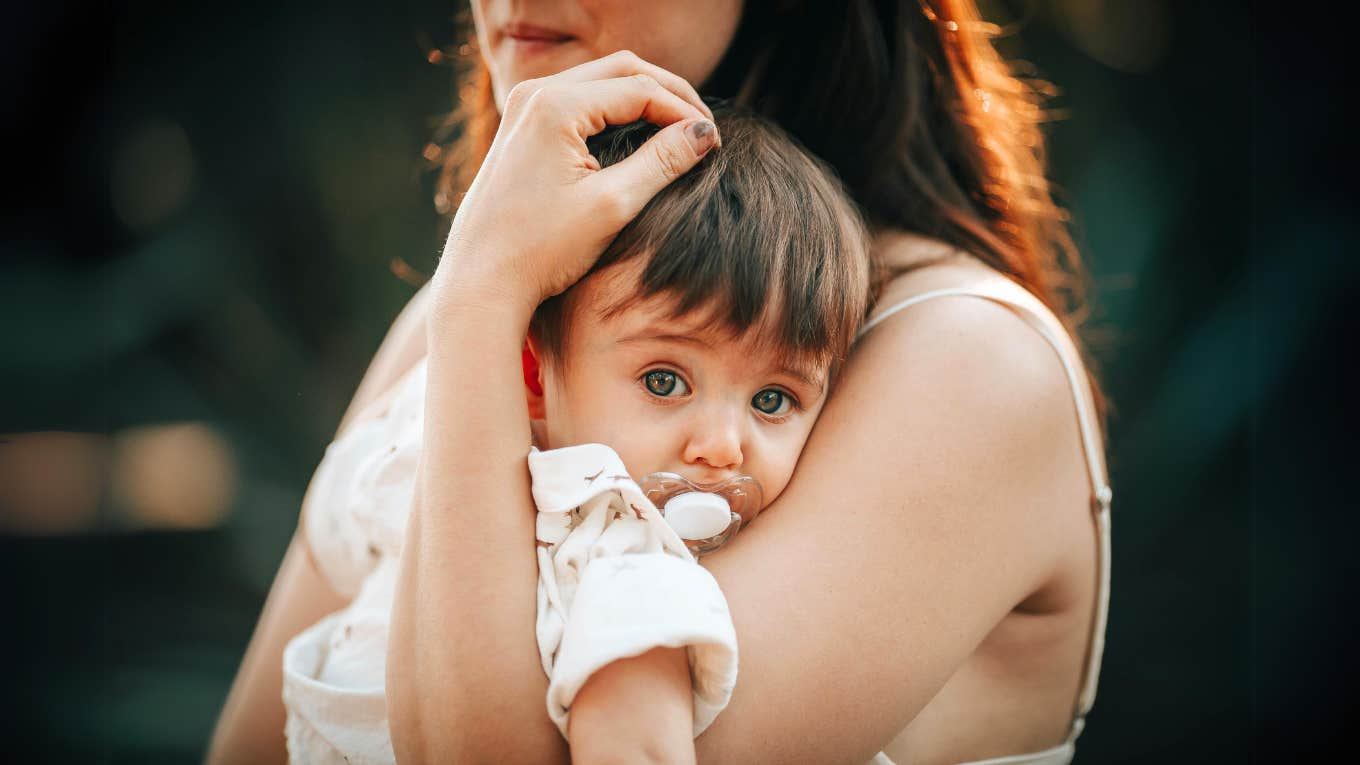 Mother holding her son who inherited the same cancer syndrome as her.