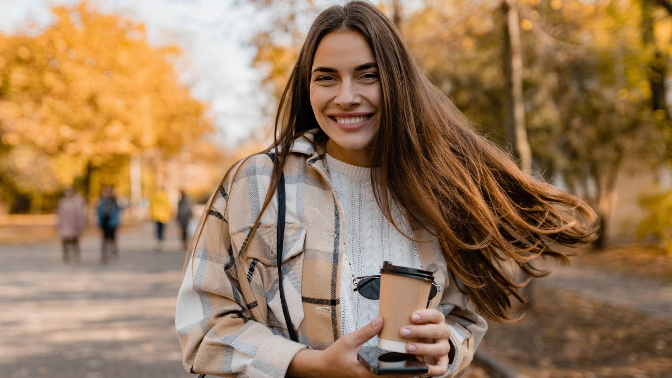 Gen Z woman doing the silent walking trend outside.