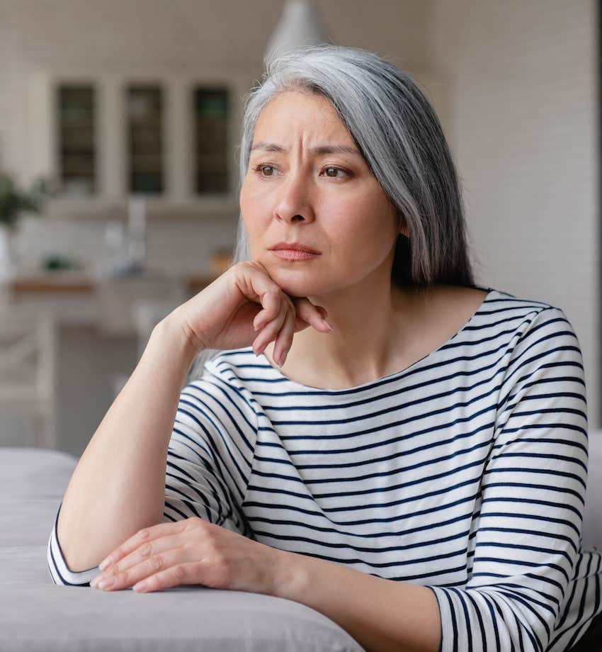 Upset woman lean chin on fist and wonder what went wrong