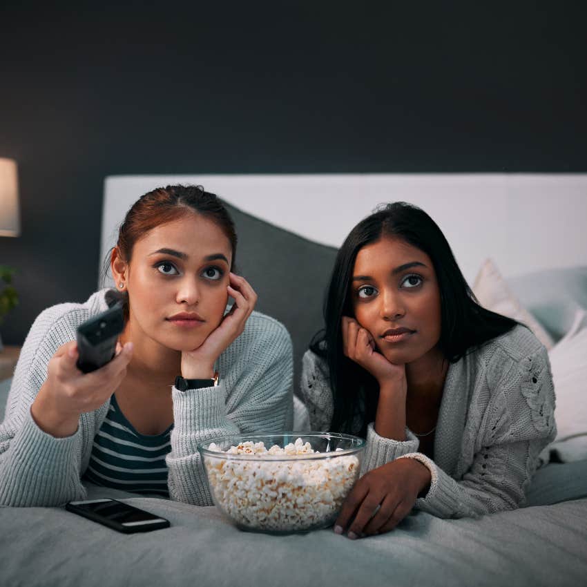 Teen girls watching movie and staying up late during sleepover