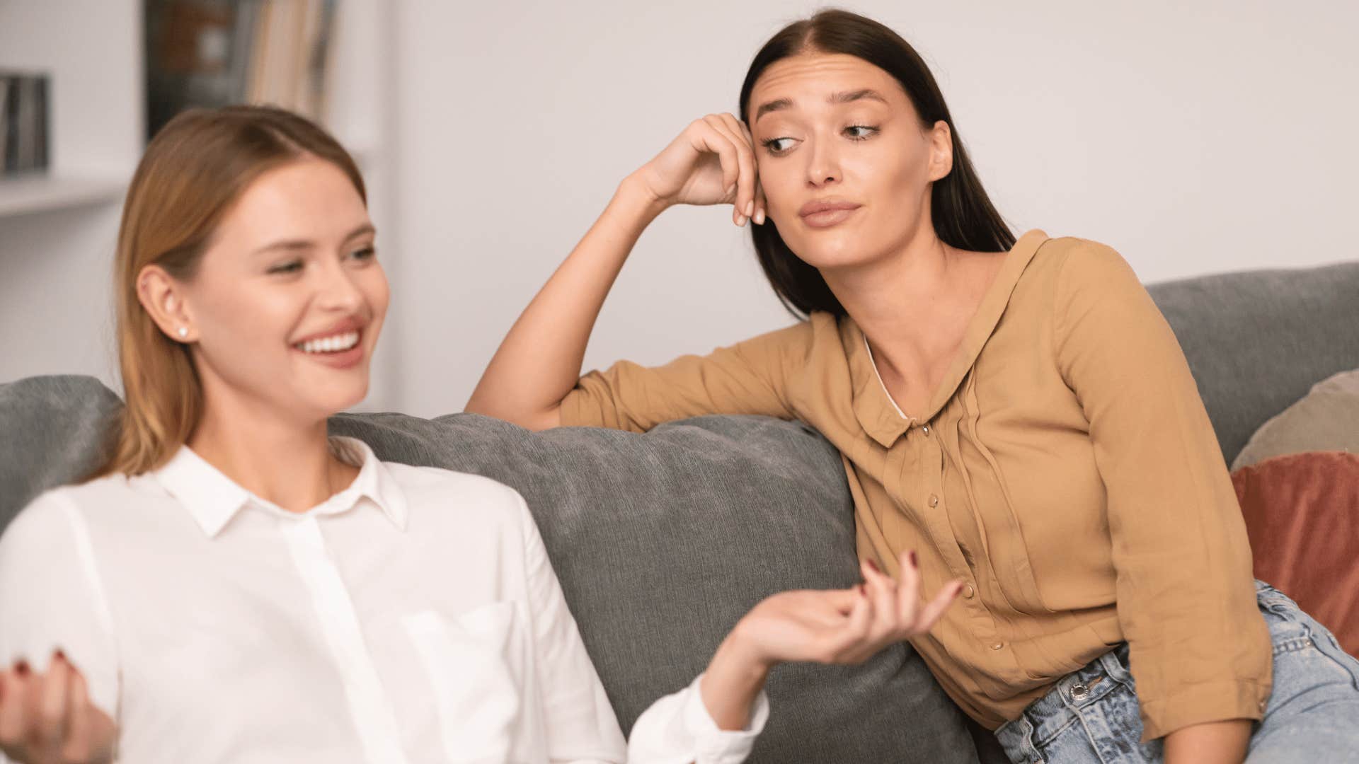 woman making a face at another woman