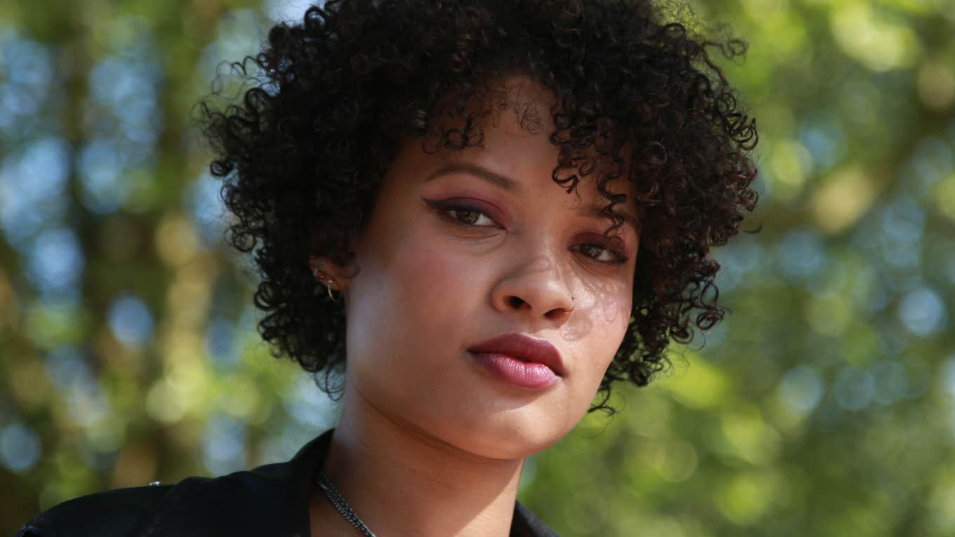 beautiful woman with curly hair looking serious