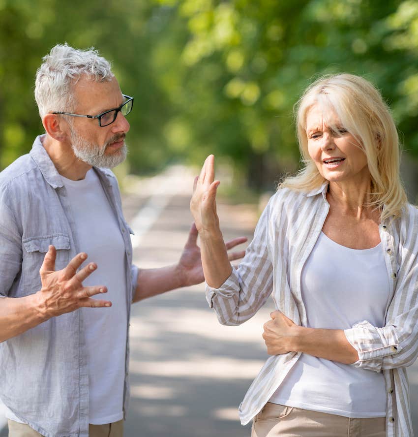 Upset man gets the hand of stop from woman enforcing boundaries