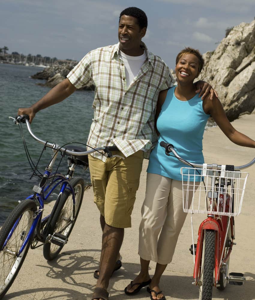 happy couple biking on vacation