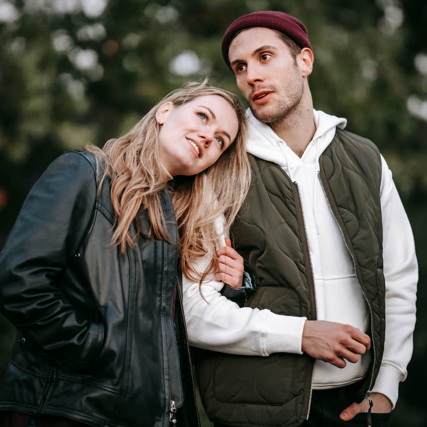 Happy couple hugging outside. 