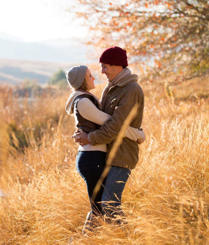 Happy couple hugging in a fall scene