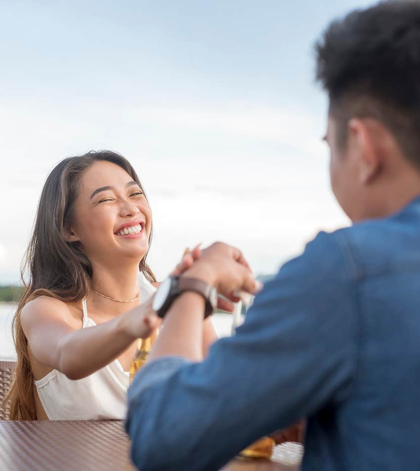 She smiles and touches his hand to communicate connection