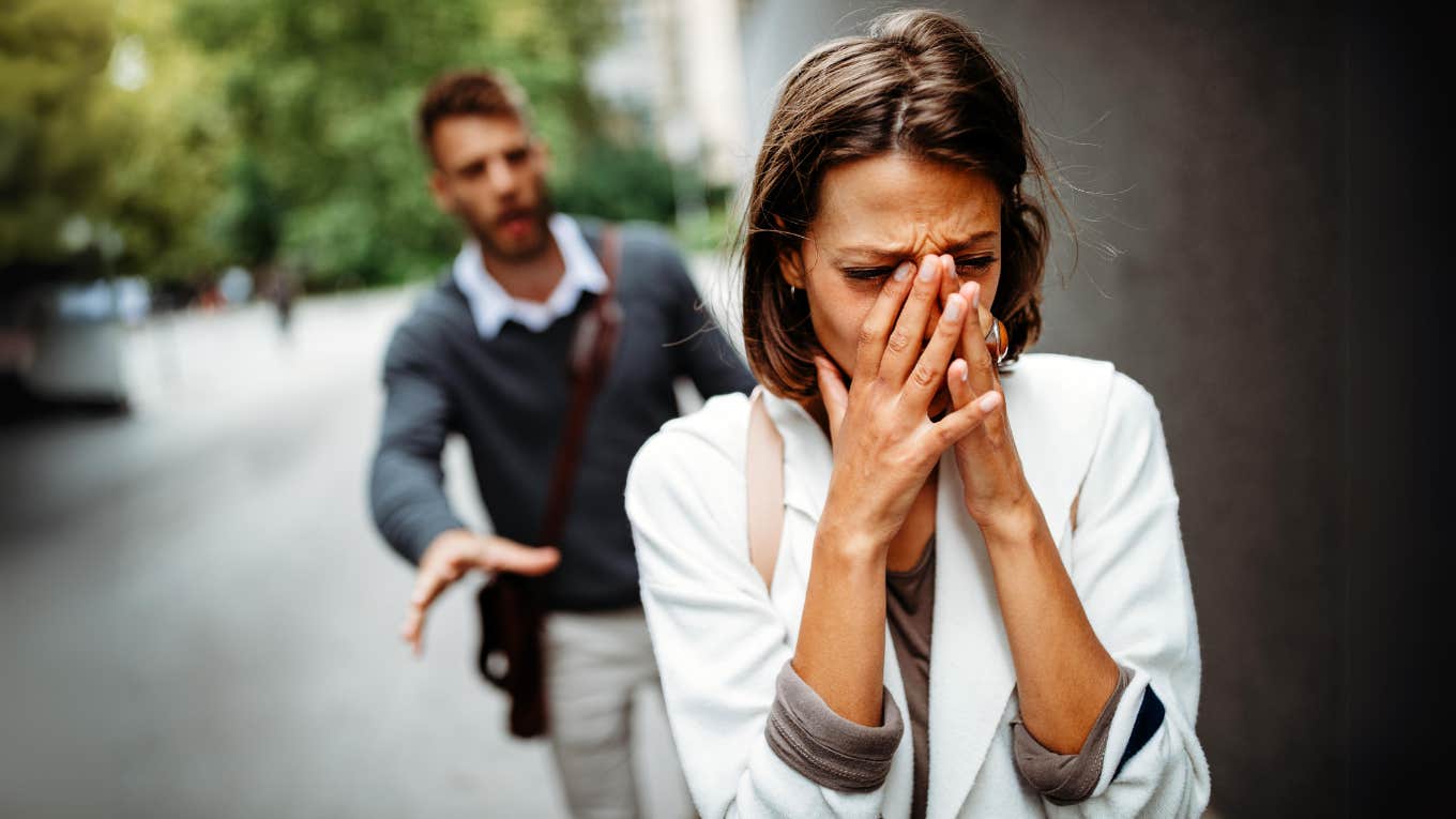 Heartbroken woman walking away from fiancé 