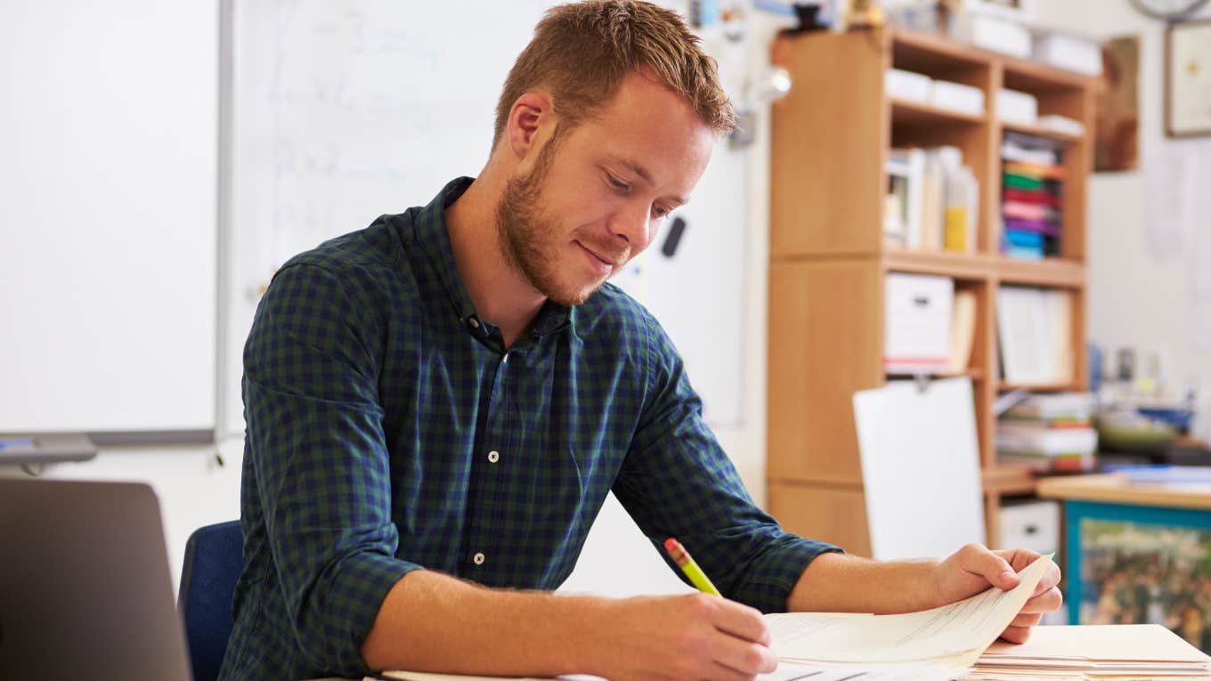 High school teacher grading papers