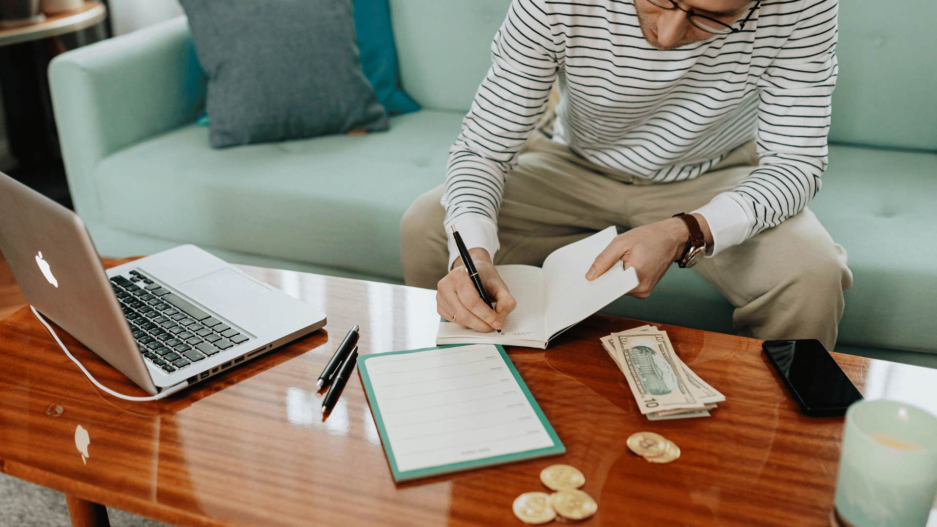 man writing an achievement list