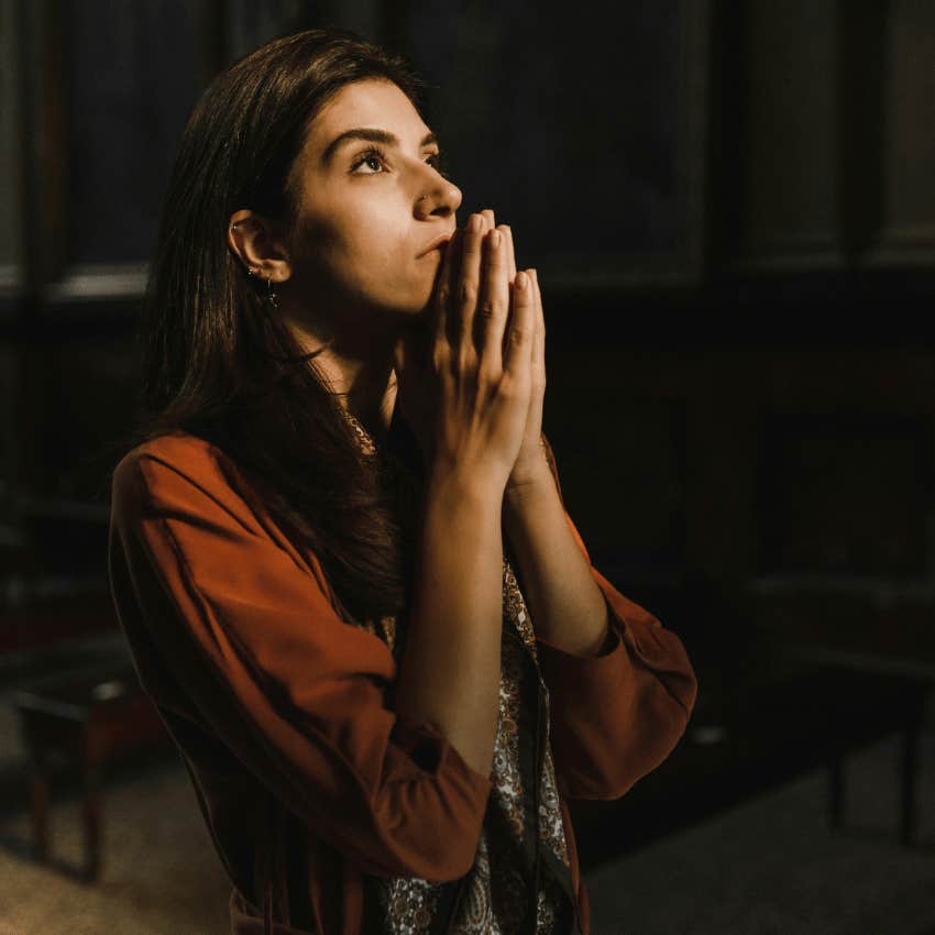 hopeful woman praying while looking up